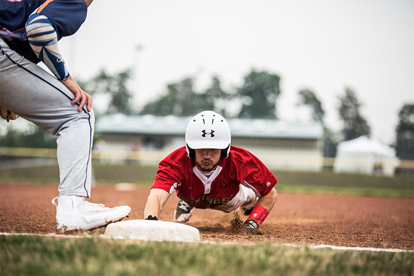 A baseball player slides into base
