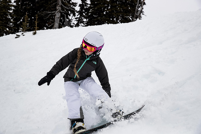 Young girl snowboarding