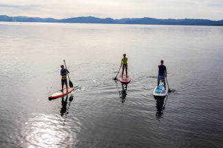 three people on stand up paddleboards