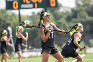 A lacrosse player practices passing the ball.