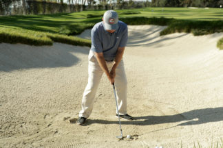 Roger Cleveland hitting out of a bunker