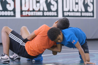 Two young wrestlers perform a switch.