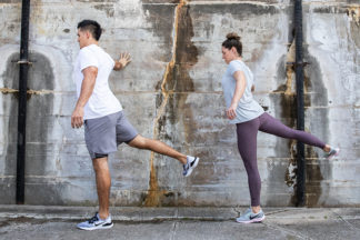 male and female doing pre-run stretches