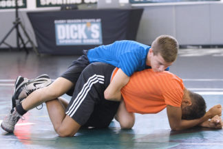 Two wrestlers demonstrate how to sprawl and score.