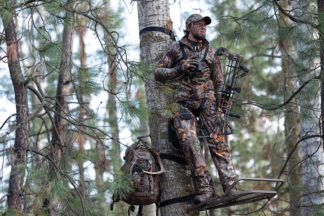 guy in camo in a treestand