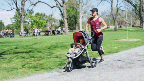 mom jogging in park with jogging stroller