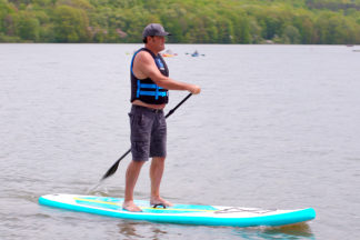 Man Paddling On Inflatable Stand Up Paddleboard