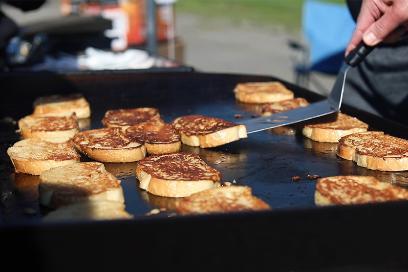 bruce mitchell cooking french toast on a blackstone griddle