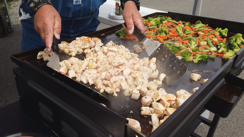 bruce mitchell cooking stir fry on a griddle