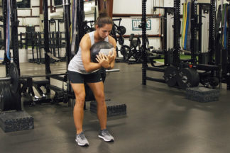 Woman Doing Hip-Hinge With Medicine Ball