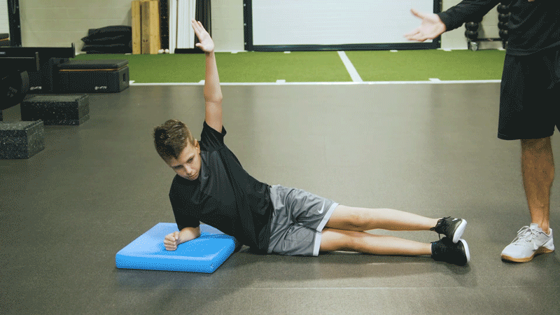 Boy Performing Side Plank With Balance Pad