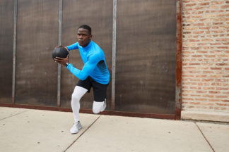 Man Doing Lateral Bound Exercise While Holding Medicine Ball