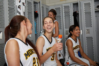 women basketball players in the locker room preparing for a basketball game