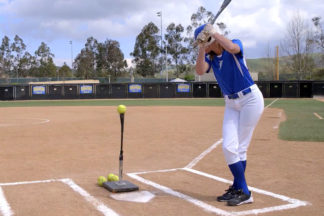 Softball Player Practicing Hitting With Batting Tee