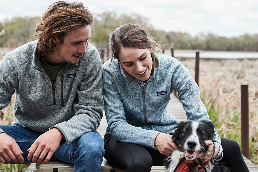 man and woman in Patagonia jackets with their dog