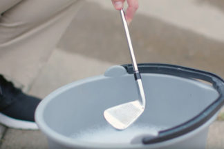 Golf Club Being Clean In Bucket Of Soapy Water