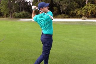 Professional Golfer Rory McIlroy Swinging A Golf Club