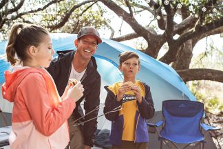 Dad and kids camping with their Quest Switchback 8 Person Cross Vent Dome Tent