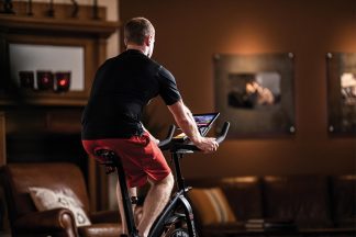 Man Riding Exercise Bike At Home