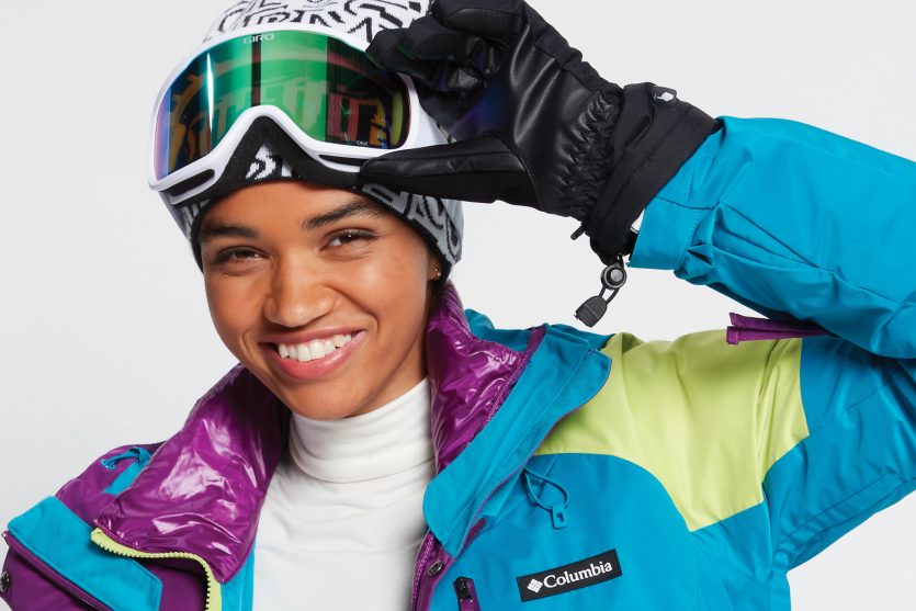 female snowboarder wearing Columbia snow jacket and snow goggles