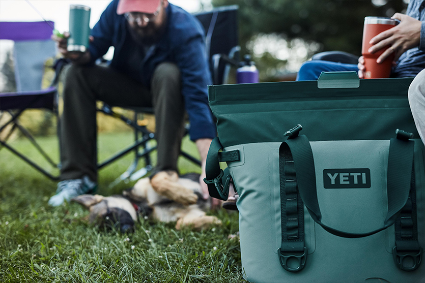 camping in a field with a yeti cooler