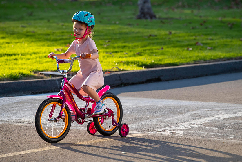 little girl riding a Nishiki Girls' Pueblo 20'' Mountain Bike on the road