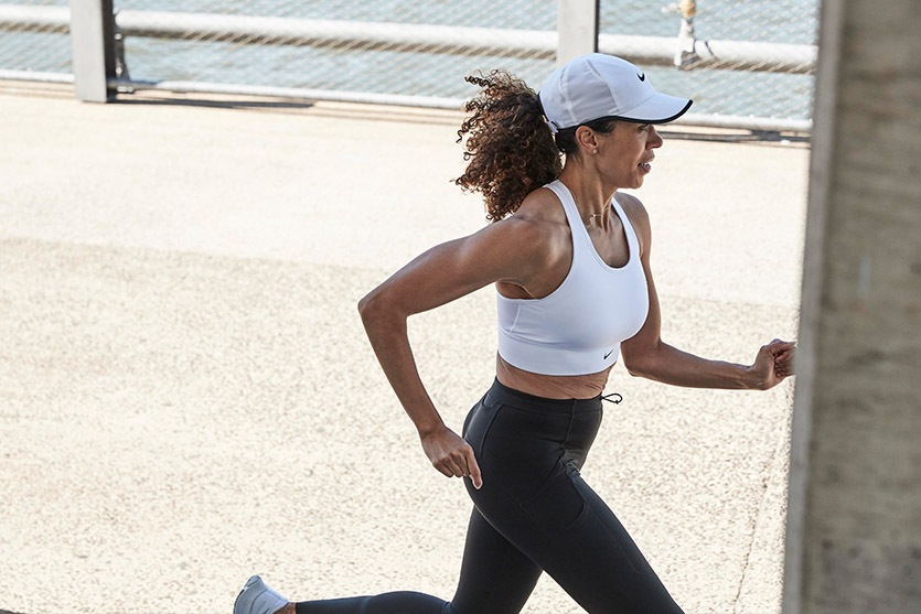 Image features woman in sports bra running