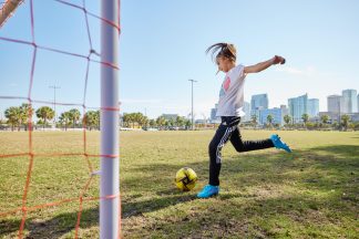 An image of a girl playing soccer.